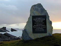 The memorial to the Reverend Norman MacLeod at Clachtoll with Split Rock in the background.